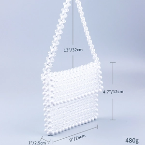 Close-up detail of white and clear acrylic bead weave on handmade handbag with dimensions
