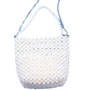 White faux pearl woven bucket bag with elegant top handle and silver metal chain strap
