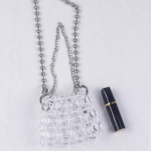 Mini transparent beaded chain bag with silver double straps and lipstick size reference