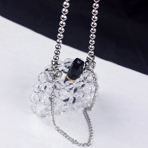 Macro detail of mini clear beaded bag showing intricate craftsmanship and chain strap