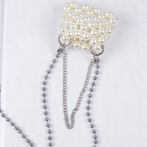Detailed view of handmade woven pearl mini bag with dual silver metal chains