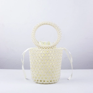 Detailed view of handmade pearl bucket bag with woven beads and drawstring satin liner