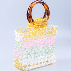 Detail of multi-colored beaded handbag with vintage tortoiseshell round handle