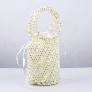 Detail of handmade pearl bucket bag with woven grid structure and satin drawstring liner
