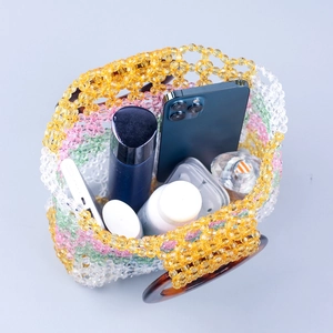 Colorful handmade beaded bag with tortoiseshell ring handles and spacious interior storage