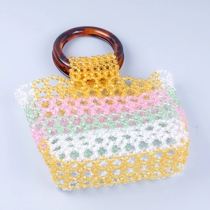 Detail of colorful acrylic beaded handbag with tortoiseshell resin ring handle