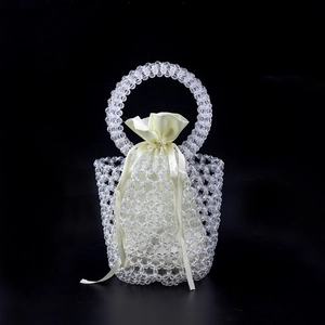 Handmade clear beaded bucket bag with beige satin drawstring liner and circular handle