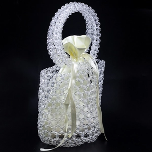Detail of handmade pearl beaded bucket bag with smooth champagne satin drawstring lining