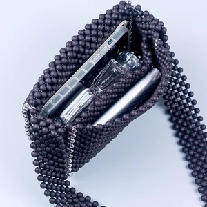 Handmade matte purple beaded crossbody bag with silver accents showing interior capacity