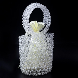 Detail of handmade beaded bucket bag with clear acrylic beads and cream satin inner pouch
