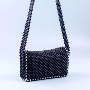 Detail of matte black beads with silver metallic accent on the handmade crossbody bag