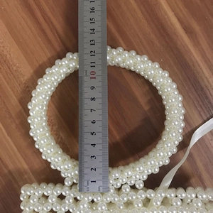 Detail view of handmade pearl bucket bag handle with 10cm inner diameter measurement