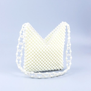 Handcrafted pearl white beaded handbag with V-neck hollow design and integrated strap