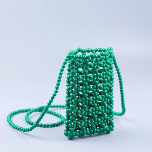 Close-up of handmade green beaded mobile phone bag with hollow woven lattice design