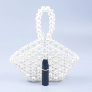 Handmade pearl woven mini bucket bag with hollow mesh design and single pearl handle