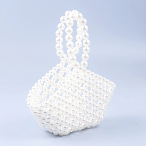Elegant handmade pearl beaded basket handbag with circular top handles and hollow-out design