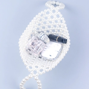 Detailed view showing capacity of white pearl woven basket bag with daily essentials
