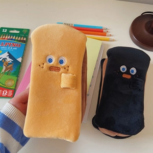 Close-up of toast-shaped plush pencil cases with cute facial embroidery and soft texture