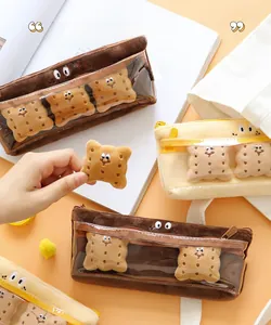 Close-up of biscuit plush pencil case featuring clear PVC window and cute small charms
