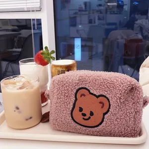 Pink plush teddy bear makeup bag made of soft sherpa fleece for cosmetic storage