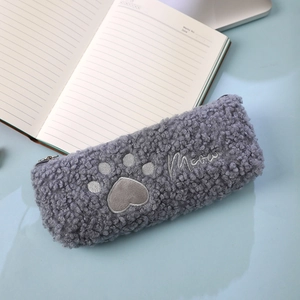 Close-up of grey plush cat paw stationery bag with heart embroidery and Meow text