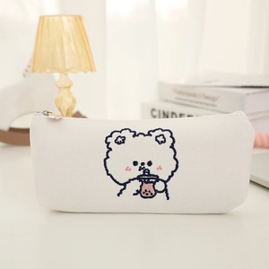 Close-up of the cute bear embroidery on the white canvas pencil case with zipper