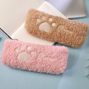 Close-up of pink and brown plush cat paw pencil cases with Meow embroidery