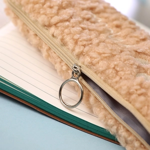 Detail of plush cat paw pencil case with soft faux fur and silver metal ring zipper