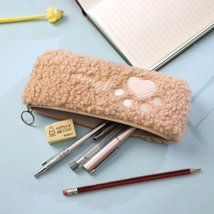 Detail of camel plush cat paw pencil case showing soft teddy fur and heart embroidery
