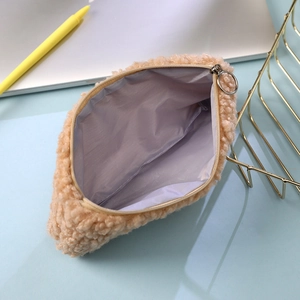 Detail of fluffy plush cat paw stationery bag with soft lining and metal ring zipper