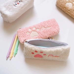 Close-up of fluffy cat paw embroidery on soft plush pencil case with zipper detail