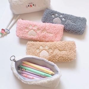 Close-up of cute plush cat paw pencil case with soft faux fur texture and embroidery