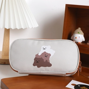 Close-up of light grey canvas pencil case featuring three cute cartoon bears with brown zipper