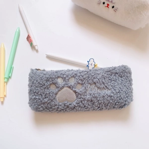 Close-up of grey plush pencil case with cute cat paw embroidery and Meow text detail
