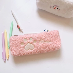 Pink plush pencil case detail with cat paw embroidery and Meow text on soft fabric