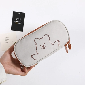 Close-up of a cartoon bear pencil case with a cute 3D bear-shaped zipper slider detail