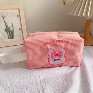 Pink corduroy makeup bag with cute rabbit embroidery and white woven carry handle