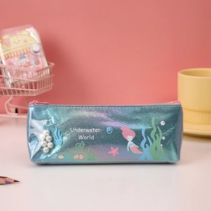 Close-up of cute mermaid pencil case with iridescent finish and cartoon ocean patterns