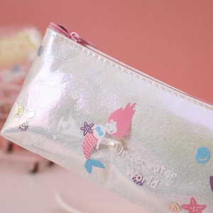 Macro shot of shimmering laser texture pencil case featuring cartoon mermaid ocean theme
