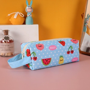 Close-up of light blue polka dot pencil case with cartoon fruits and side handle