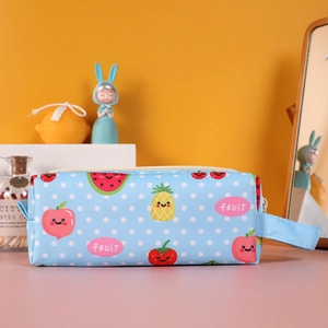 Close-up of light blue polka dot pencil case with colorful cartoon fruit prints and zipper