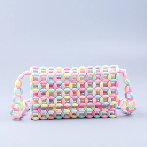 Macro detail of handmade colorful acrylic egg-shaped beads in sweet pastel plaid weave