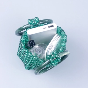 Interior detail of green acrylic beaded mini bag showing capacity for phone and perfume