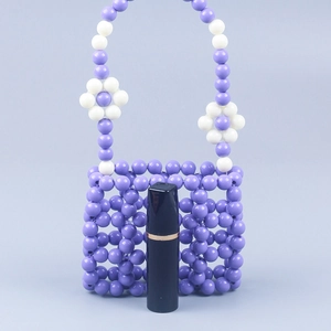 Macro detail of purple handmade beaded bag showing lattice texture and lipstick scale