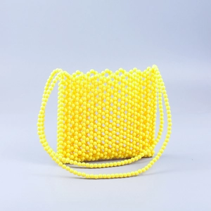 Detailed grid view of handmade bright yellow acrylic beaded shoulder bag mesh texture
