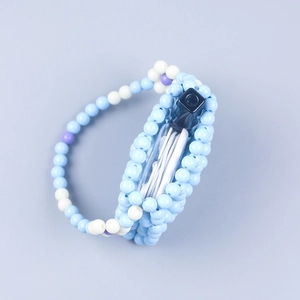 Detail of a handmade beaded mini bag with light blue and white floral pattern