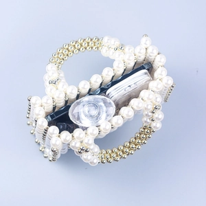 Handmade pearl beaded handbag with gold accents showing interior storage and phone capacity