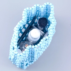 Blue acrylic beaded hollow lattice tote bag showing large capacity for cosmetics