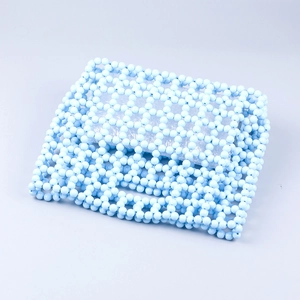 Detail of light blue acrylic beads and woven lattice structure of the handmade handbag