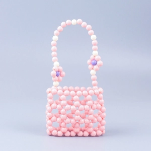 Handmade beaded mini handbag in pink with grid pattern and floral daisy accents